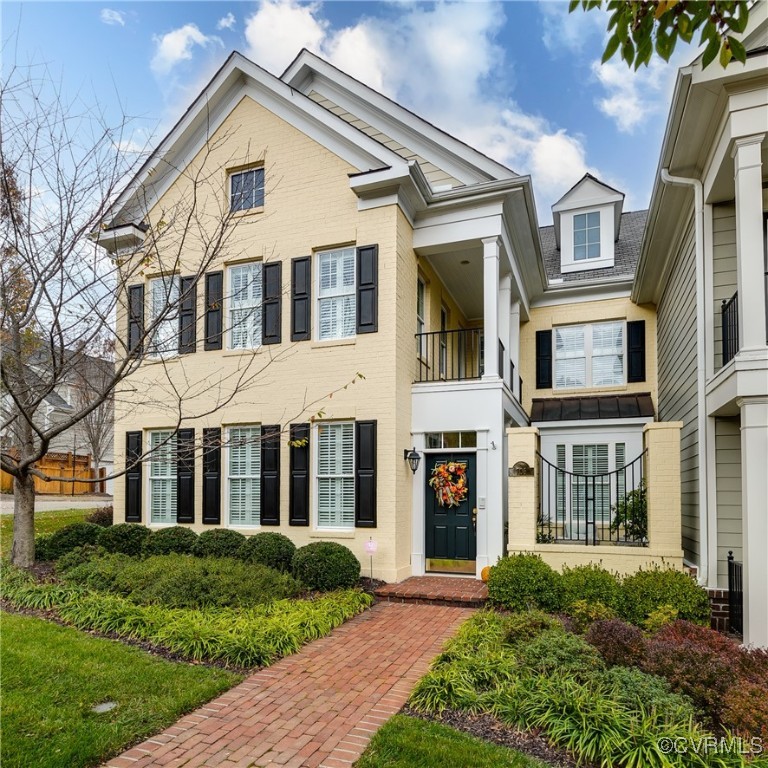 a view of brick house with a yard