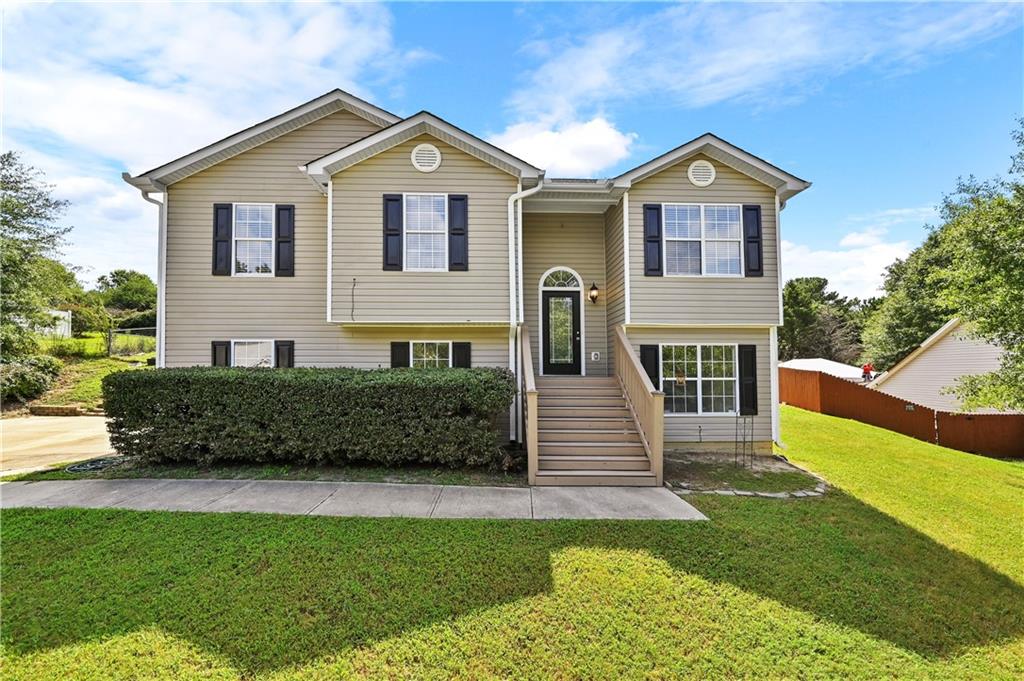 a front view of a house with a yard