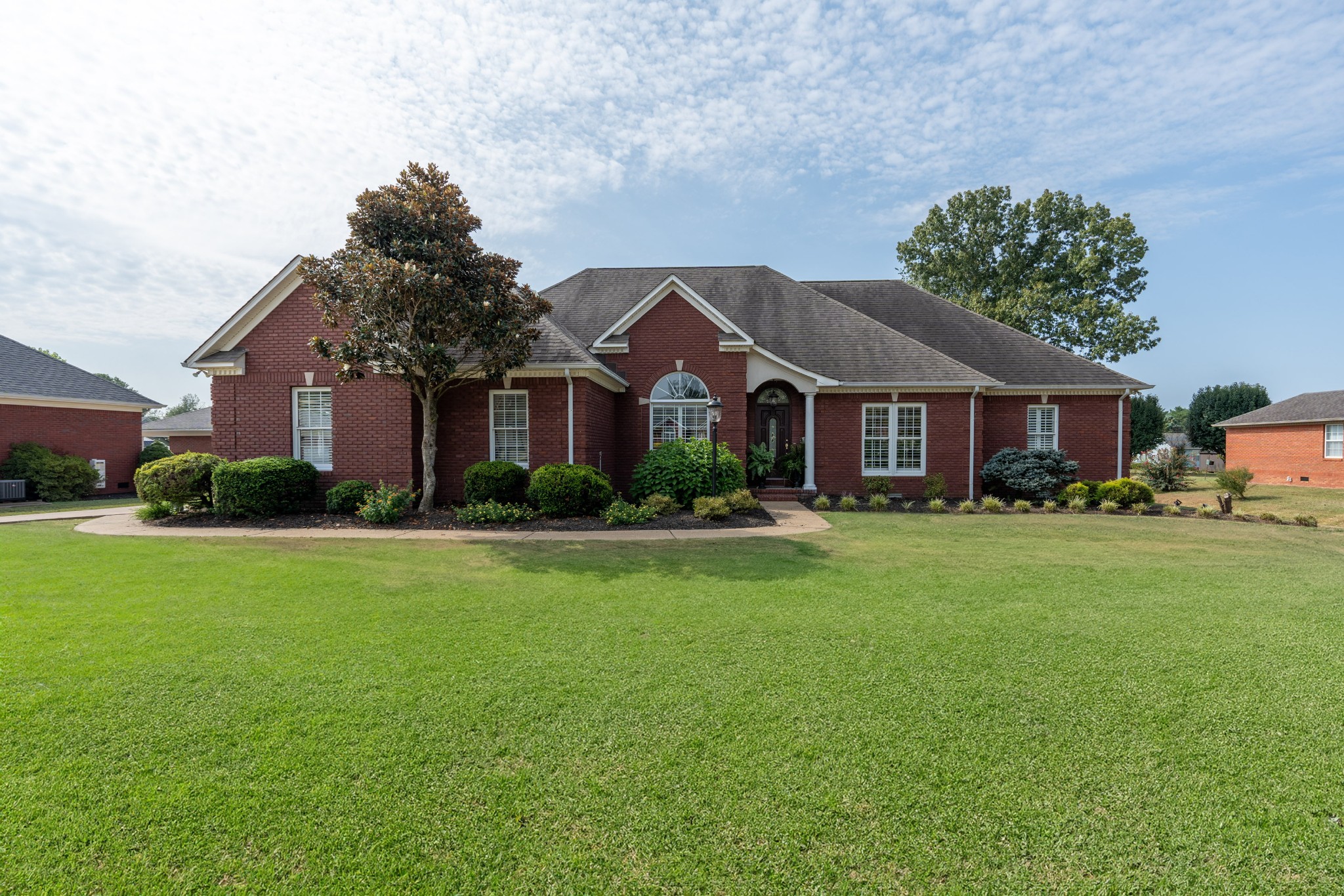 a front view of house with yard and green space