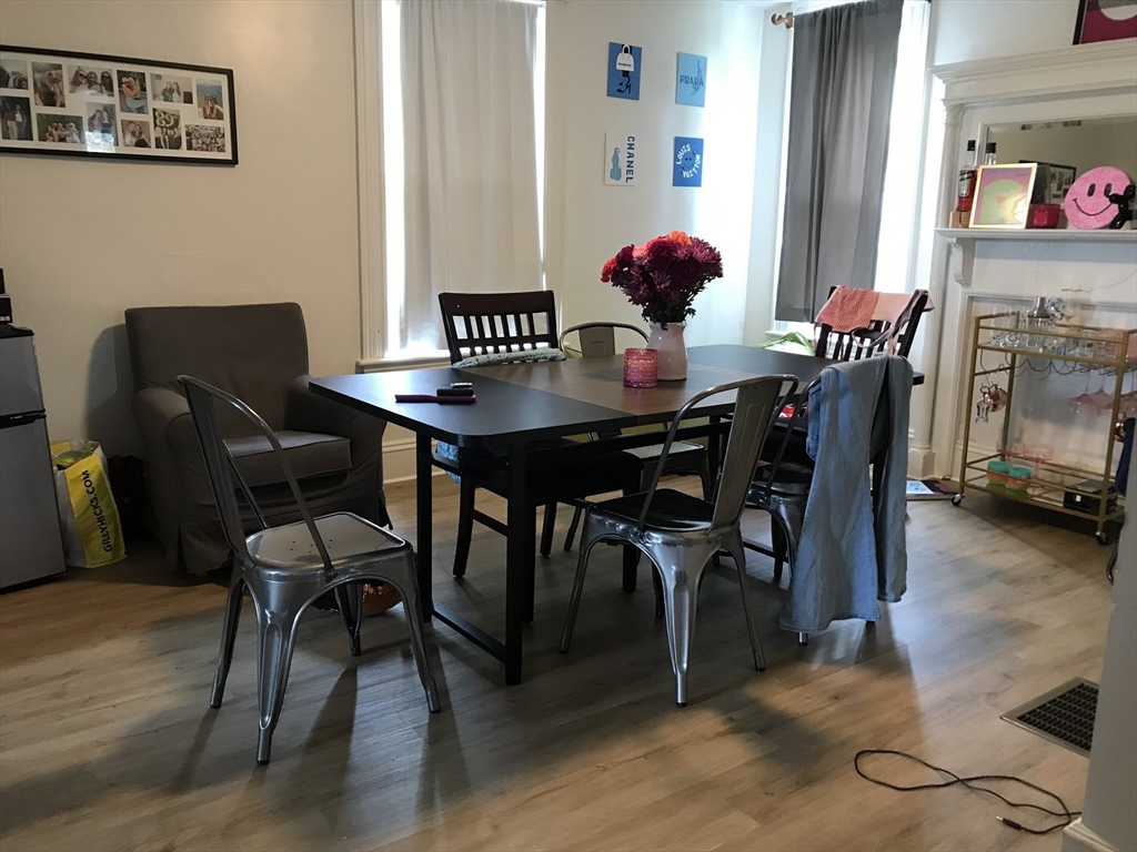 a view of a dining room with furniture and wooden floor