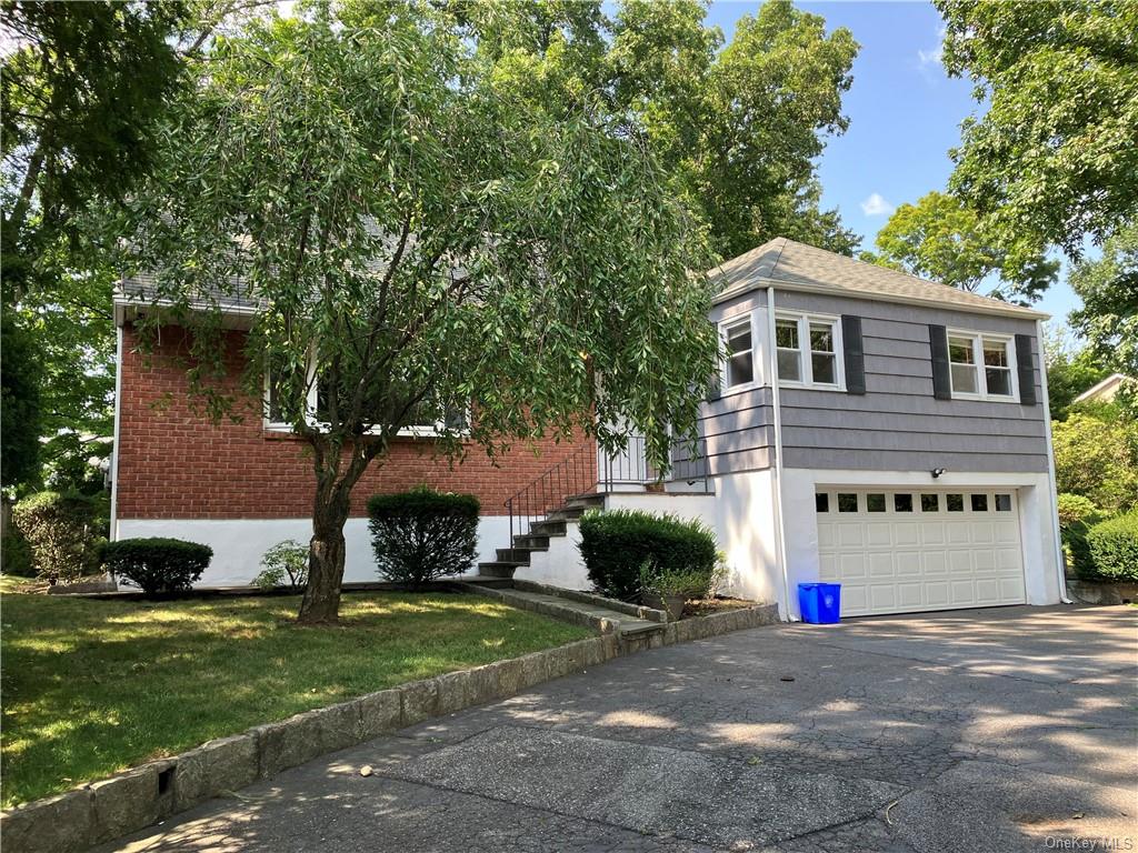 a front view of a house with a yard and a garage