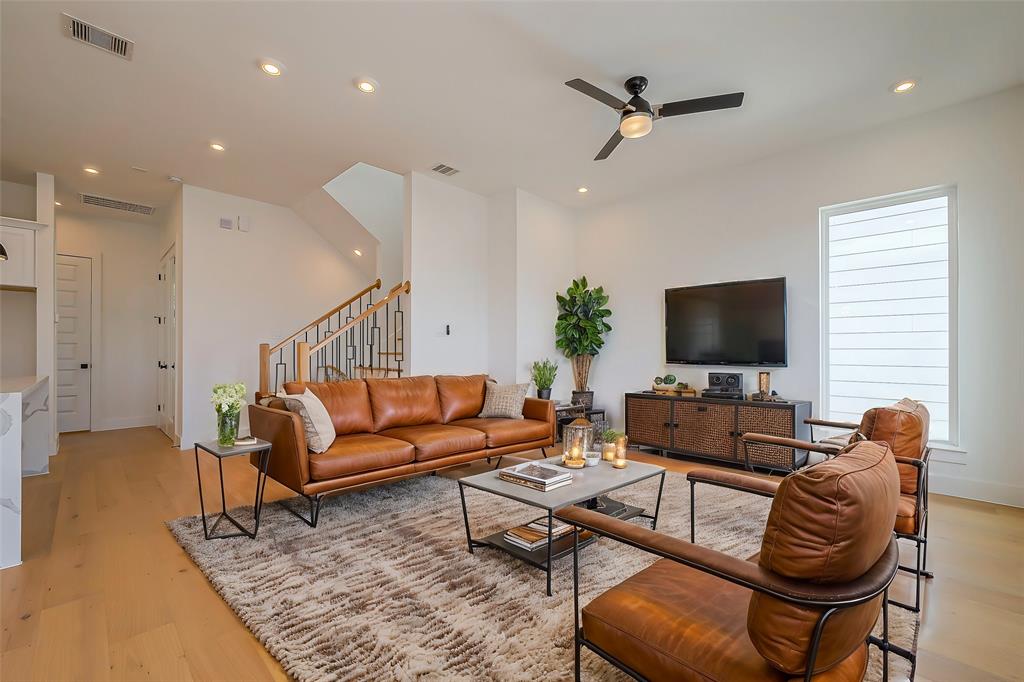 a living room with furniture ceiling fan and a rug