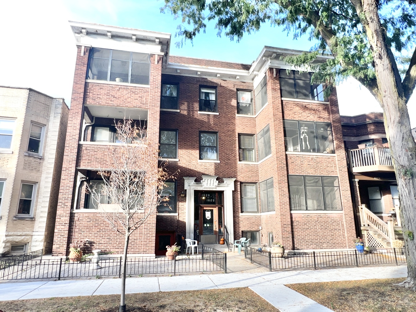 a front view of a residential apartment building with a yard