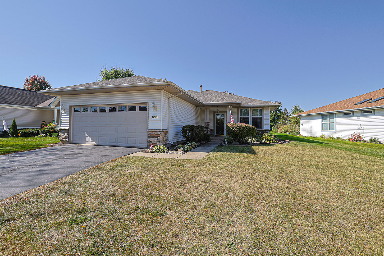 a front view of a house with a yard and garage