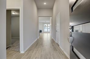 a view of hallway with wooden floor