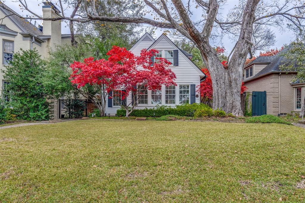 a front view of house with yard and trees