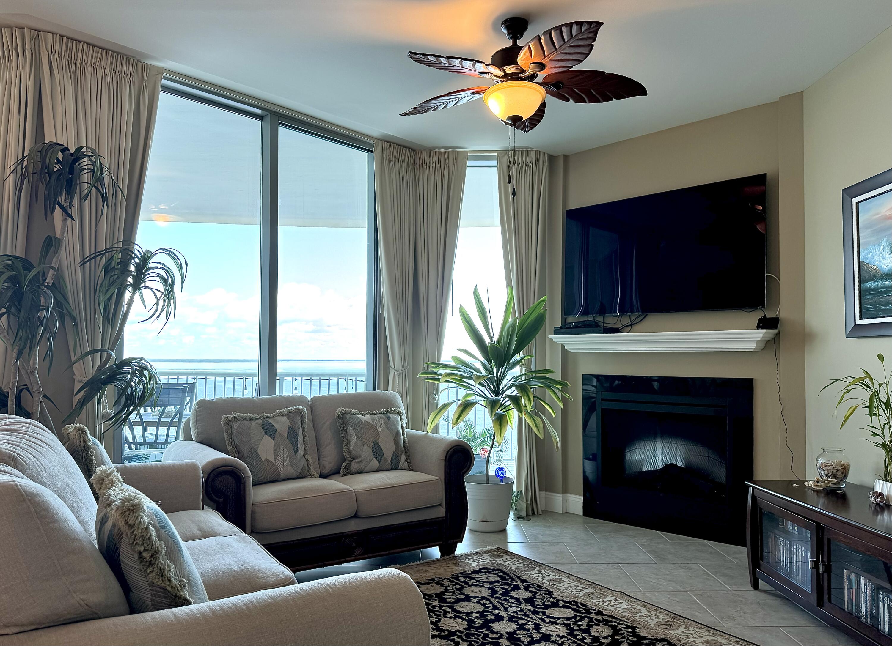 a living room with furniture a fireplace and a flat screen tv