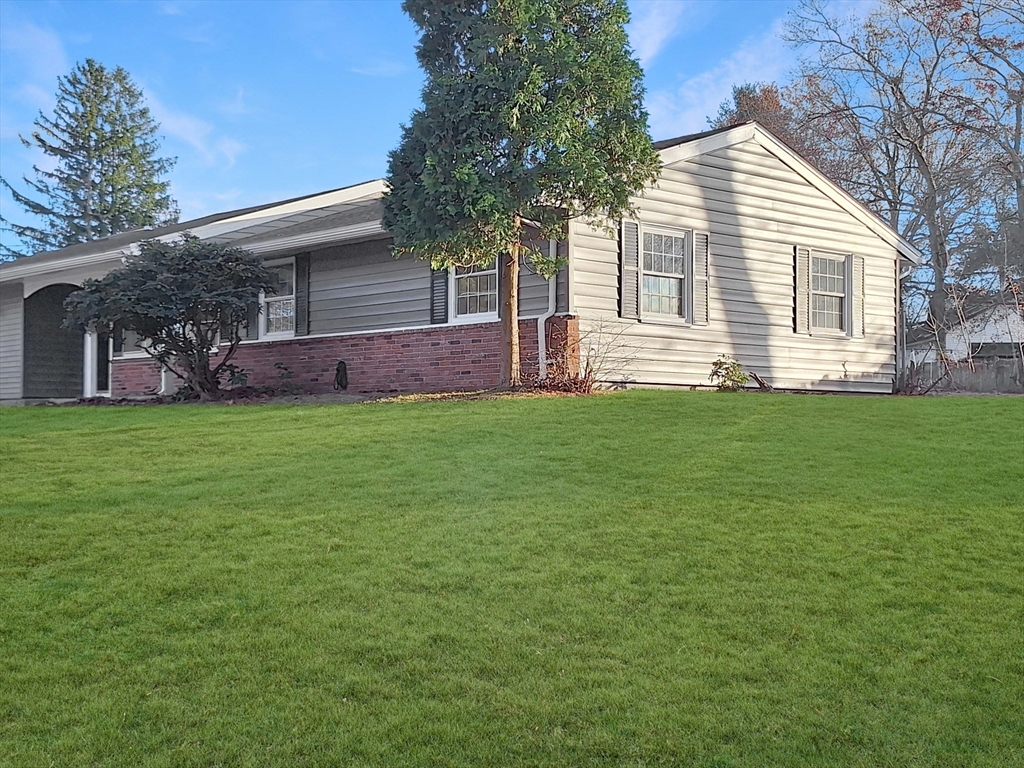 a view of a house with a backyard