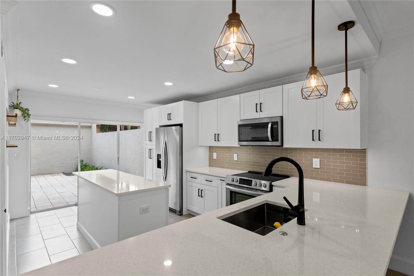 a kitchen that has a lot of cabinets and refrigerator in it