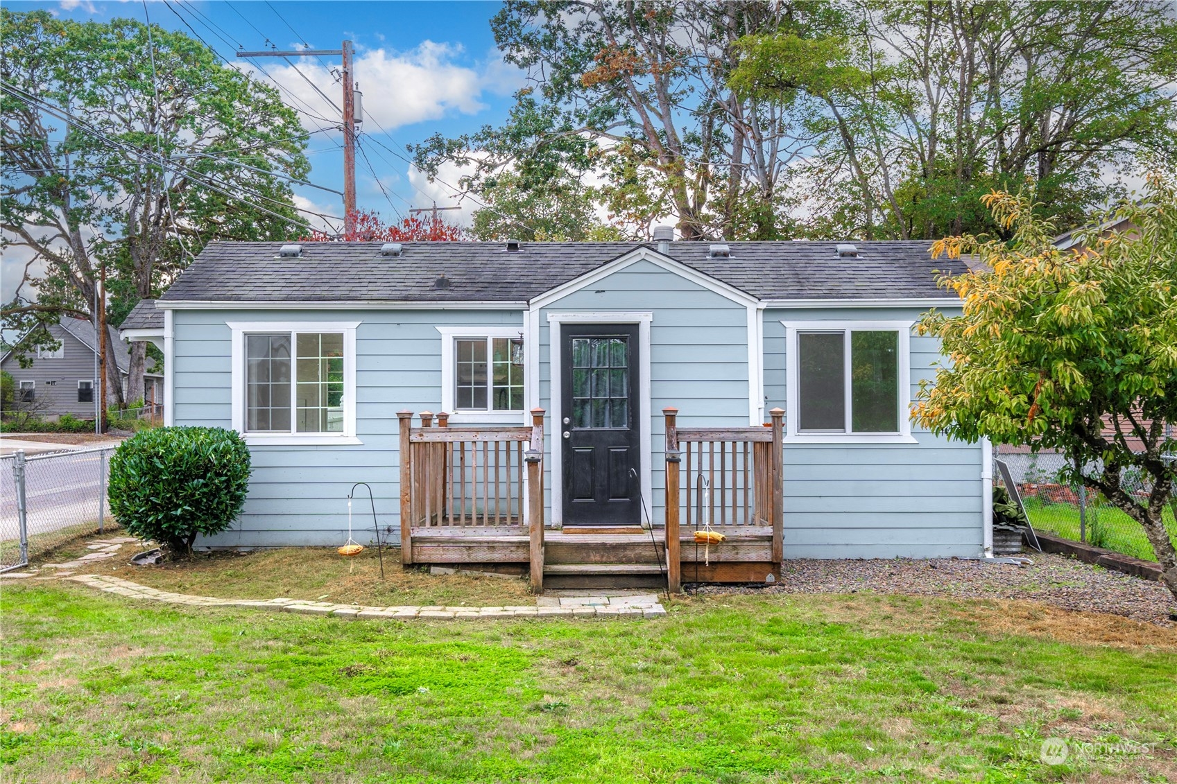 a front view of a house with a garden