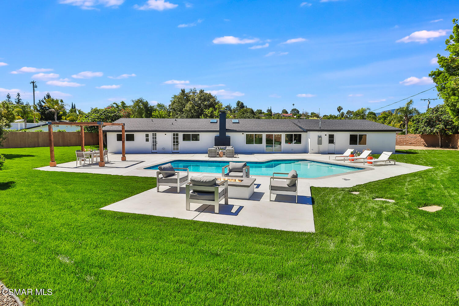 a view of a house with a backyard porch and sitting area