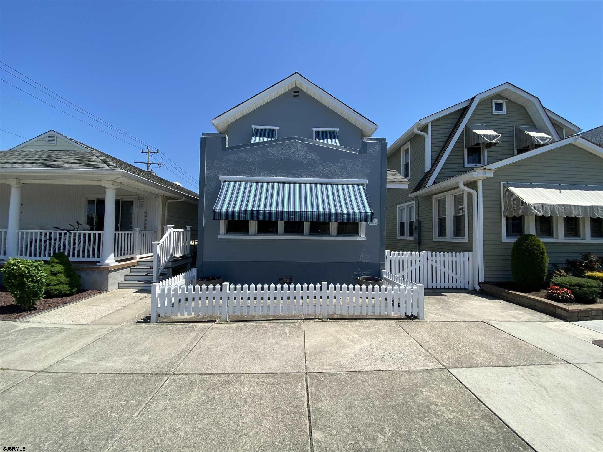 a front view of a house with a iron gate