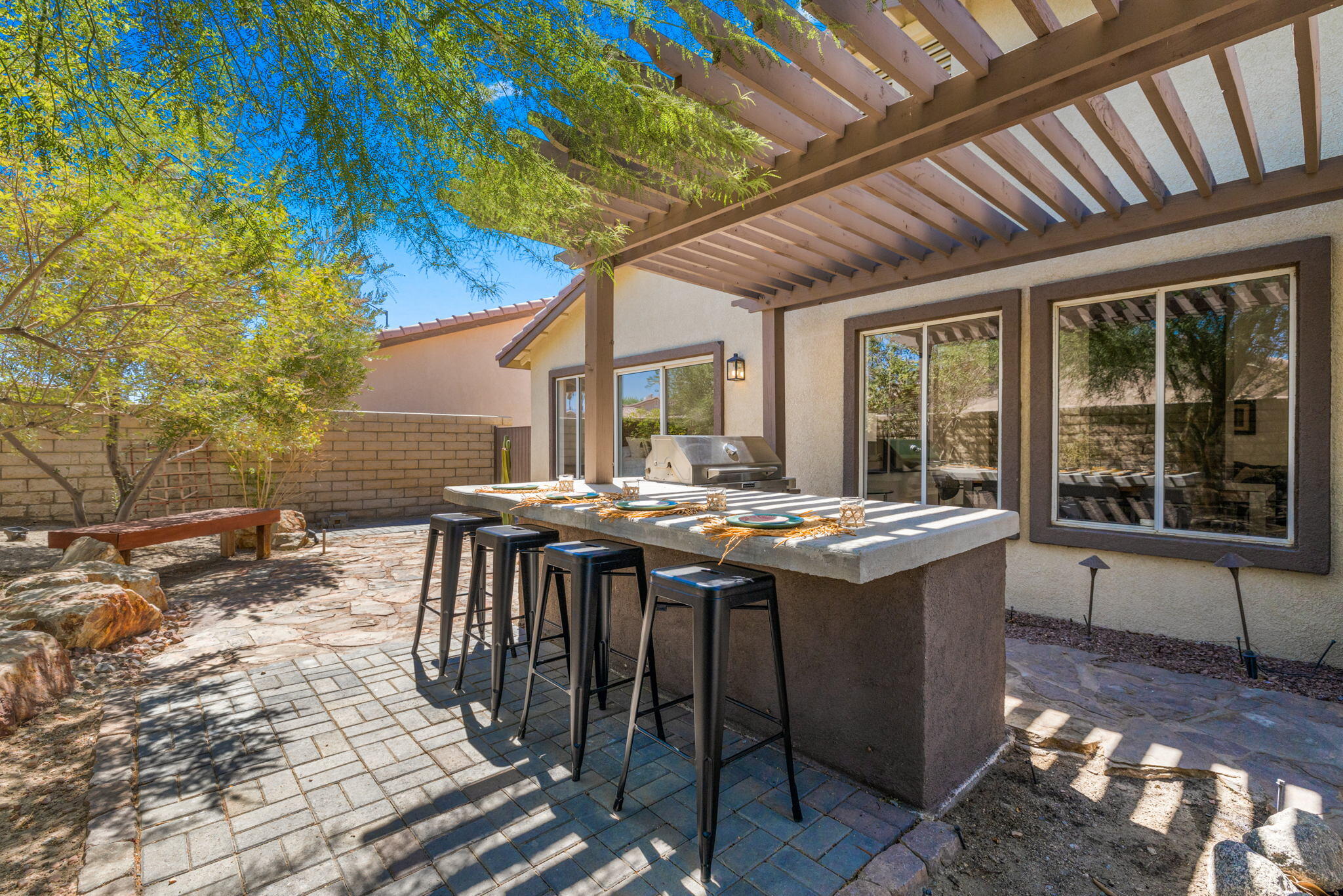 a view of a patio with table and chairs with wooden floor and fence