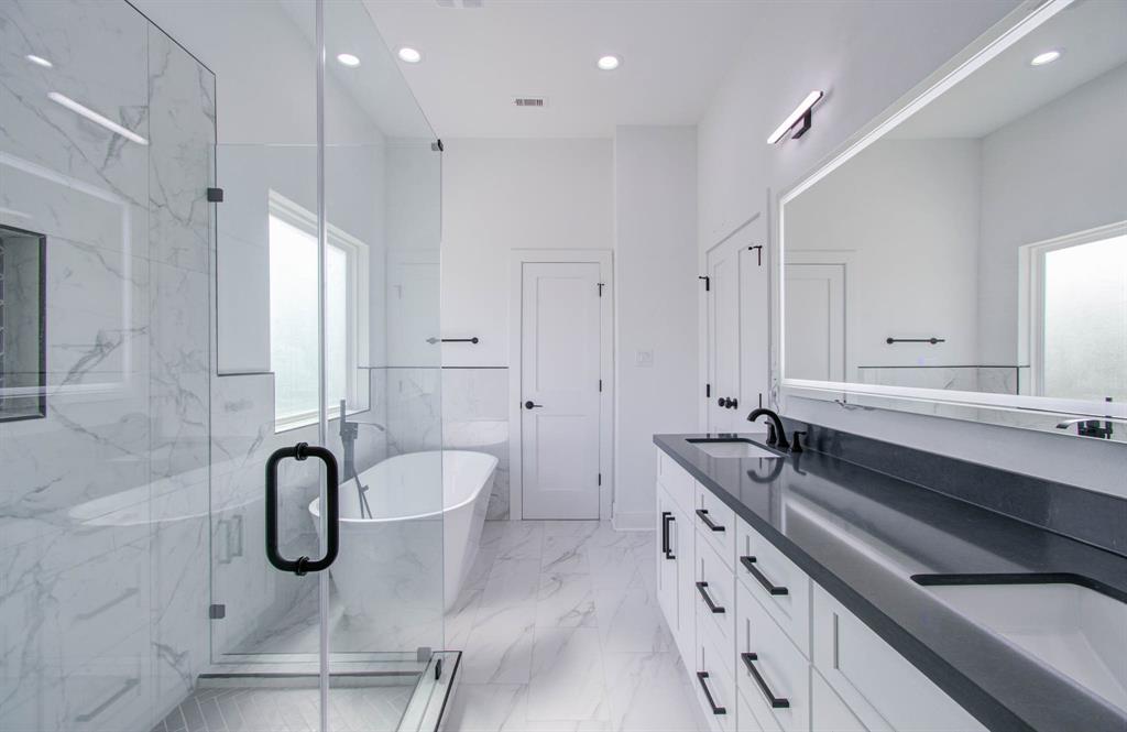 a bathroom with a granite countertop sink a toilet a mirror and shower