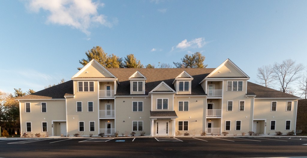 a front view of residential houses with yard