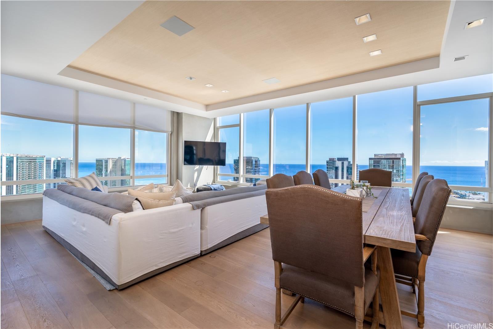 a living room with furniture kitchen view and a large window