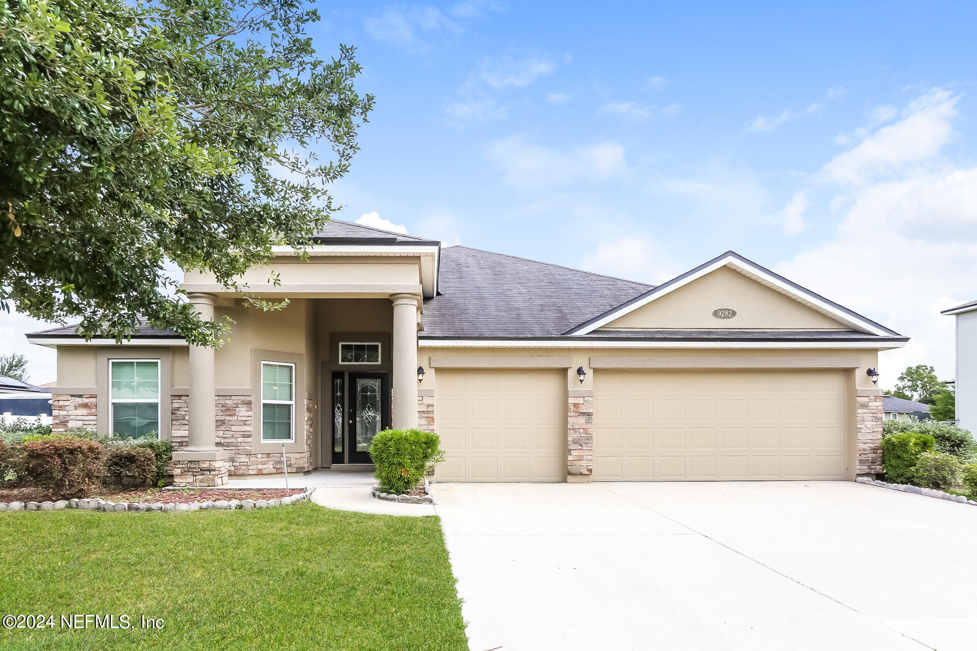 a front view of a house with a yard and garage