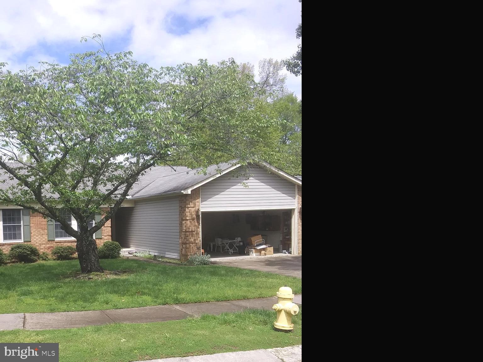 a front view of a house with a garden and yard