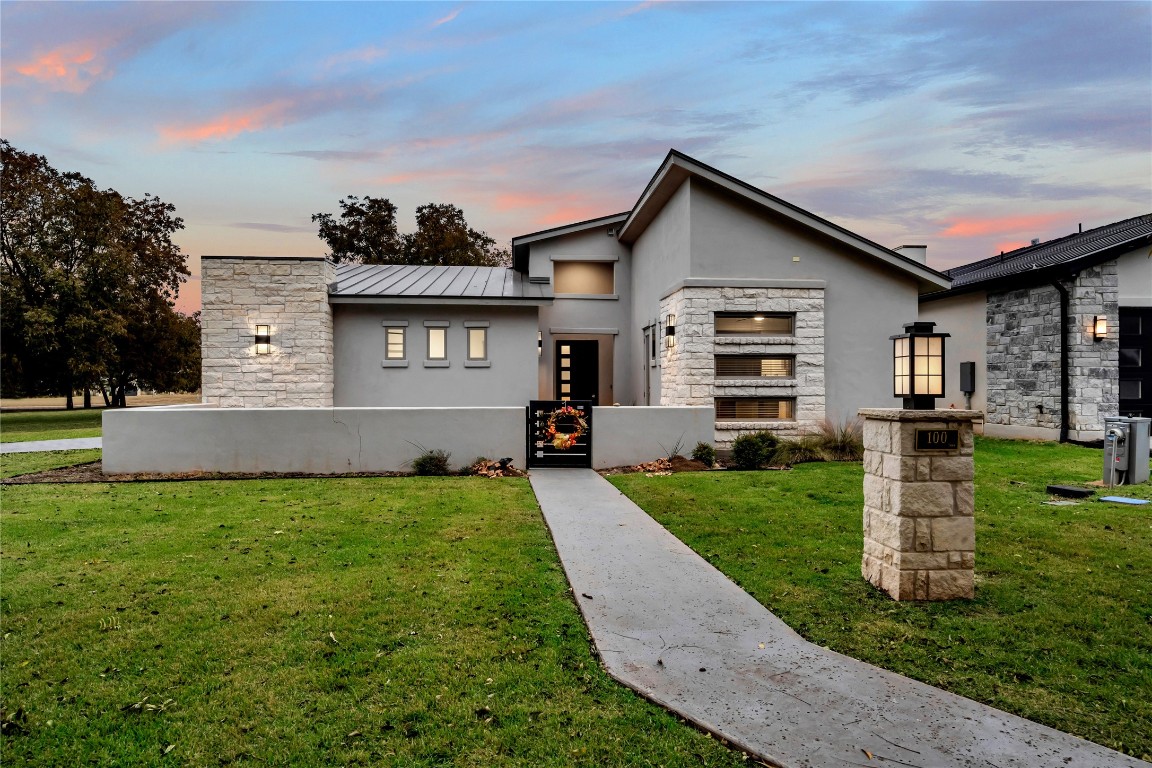 a front view of house with yard and green space