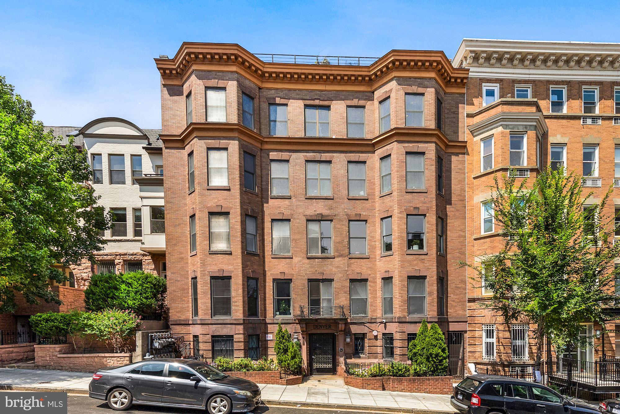 a front view of a residential apartment building with a yard