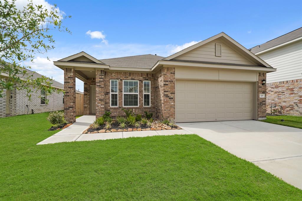 a front view of a house with a yard and garage