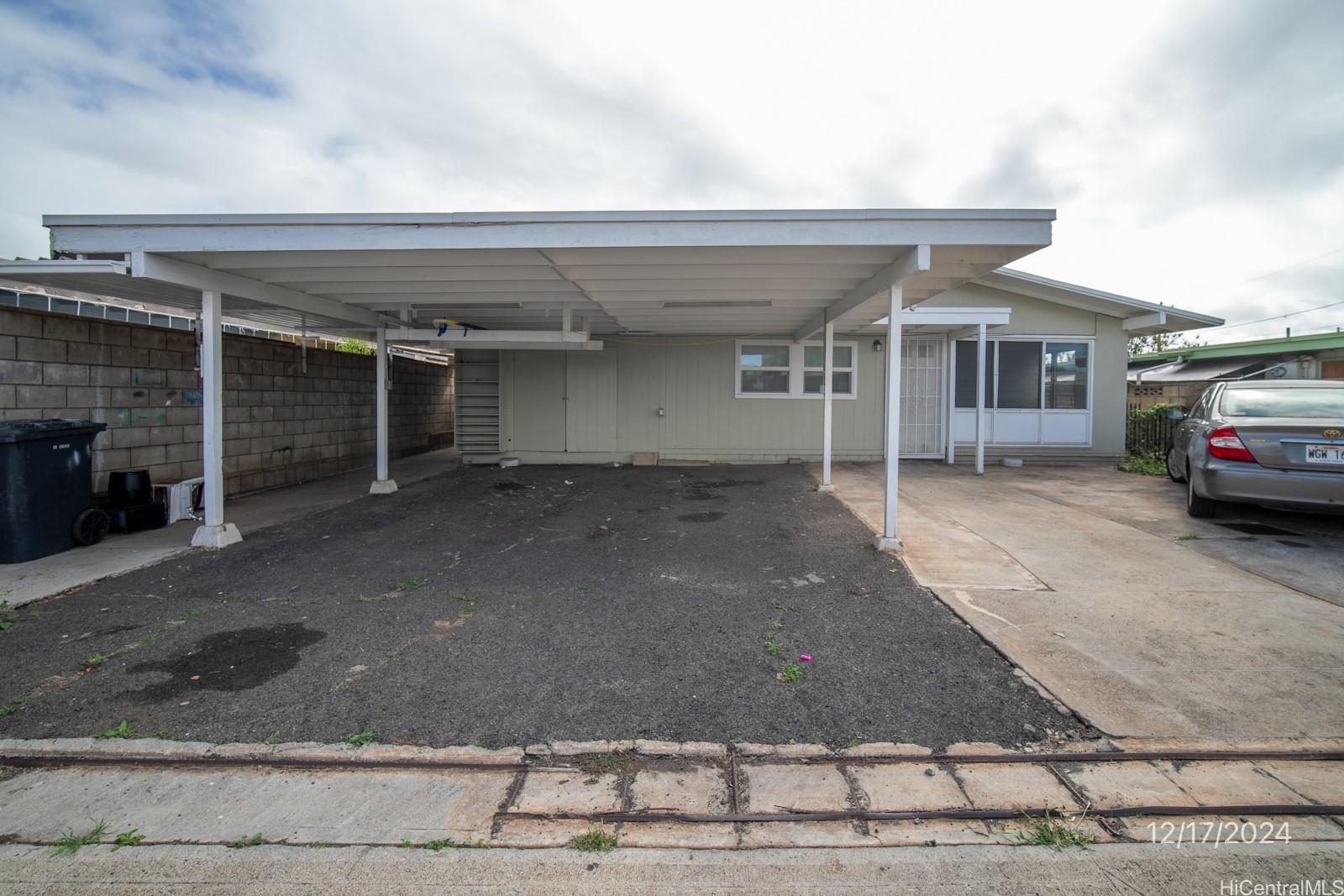 a view of a car park in front of house