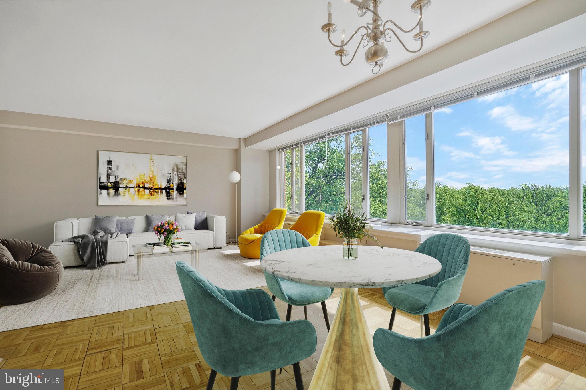 a living room with patio furniture and a floor to ceiling window