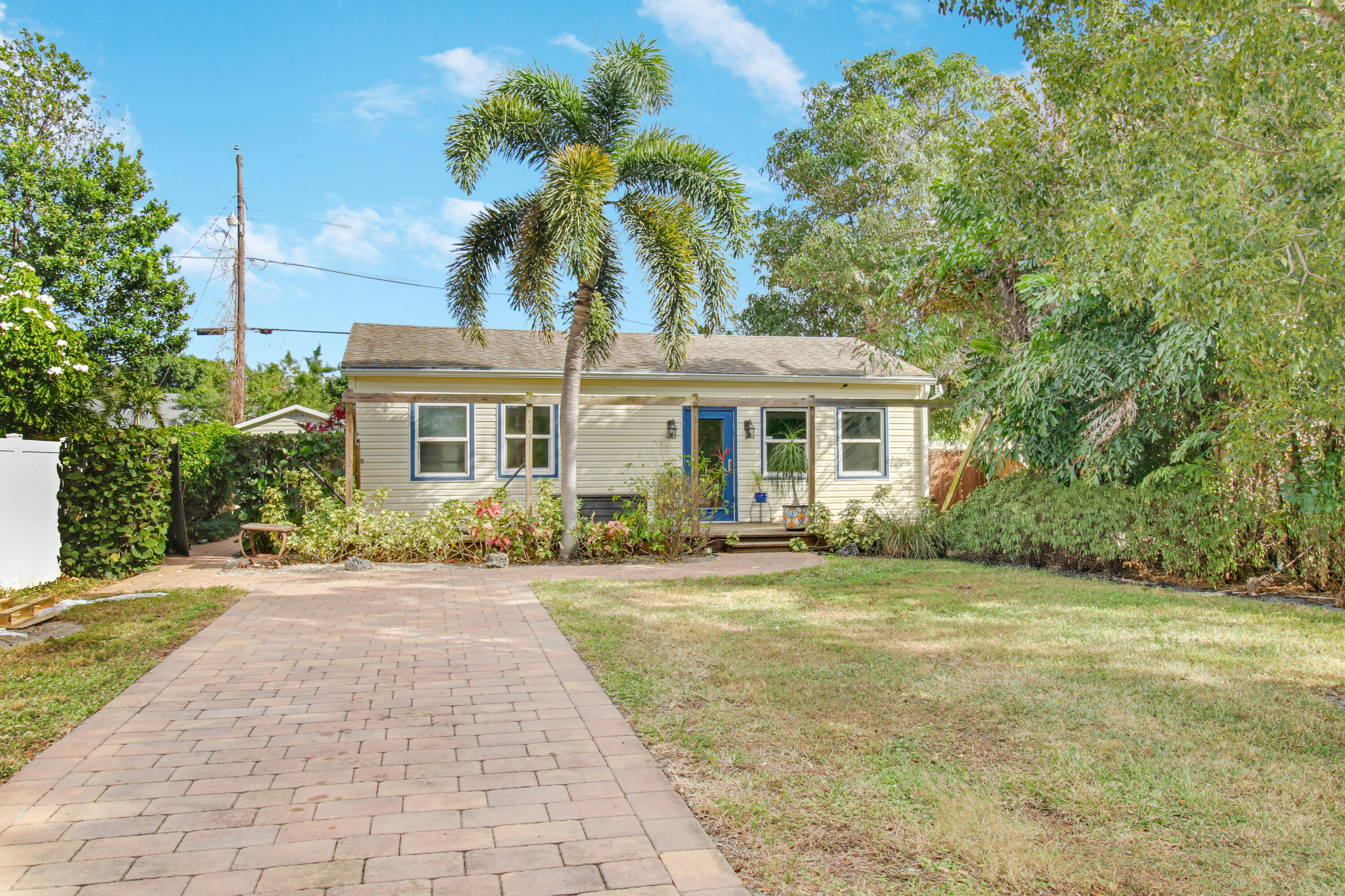 a front view of a house with a garden