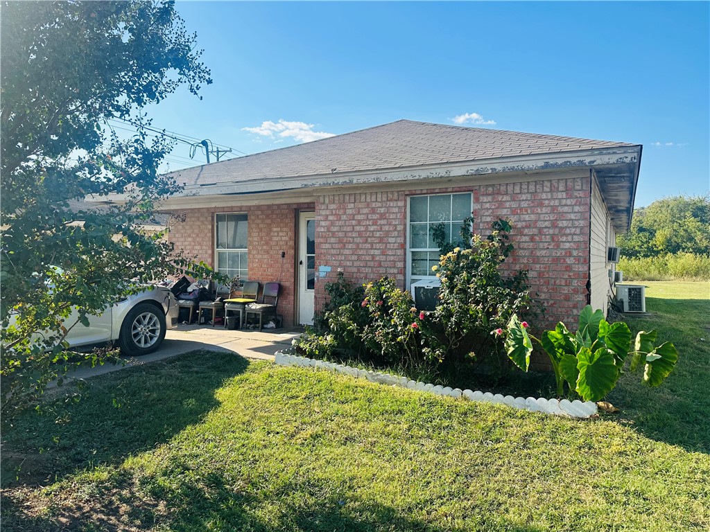 a front view of a house with garden and porch