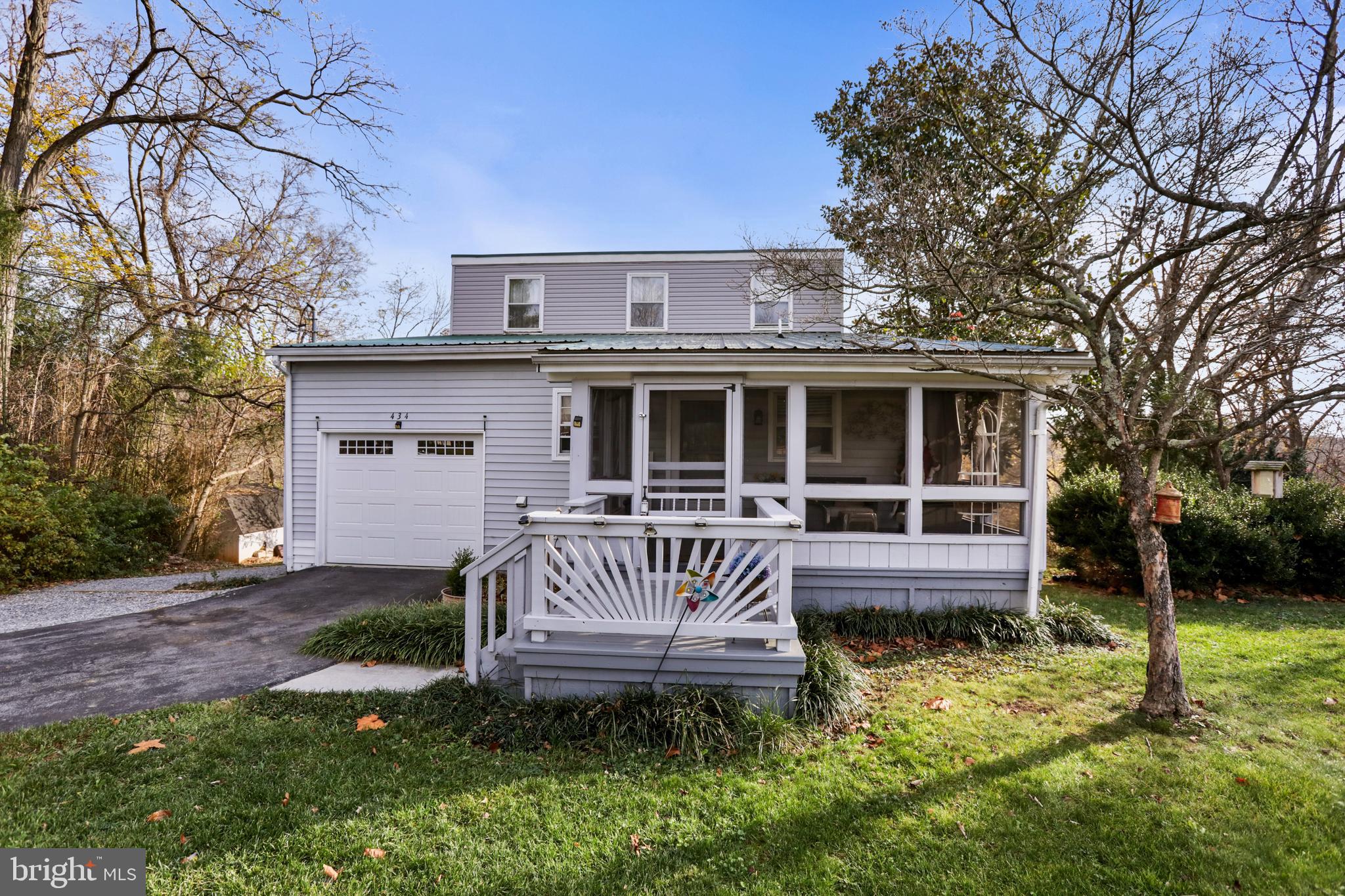 a view of a house with a yard and deck