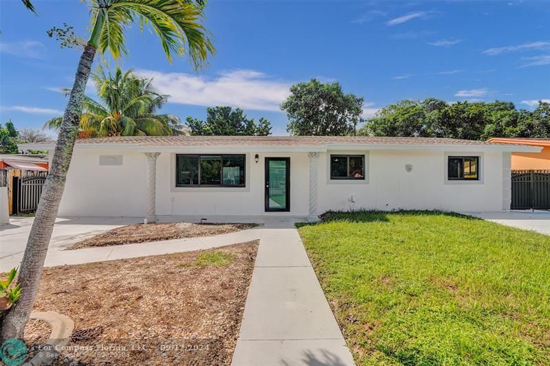 a view of a house with palm trees