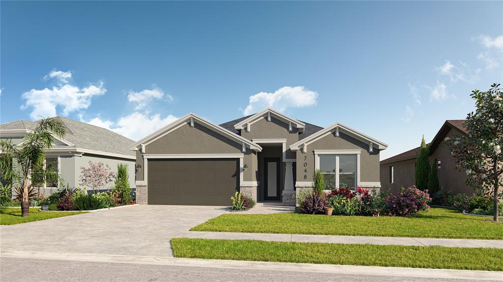 a front view of a house with a yard and garage