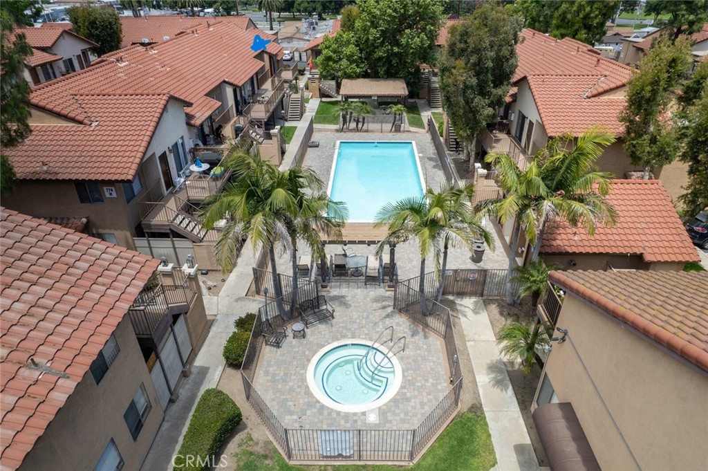 an aerial view of a house with outdoor space and trees all around