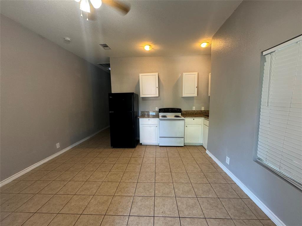 a kitchen with a cabinets and a stove top oven