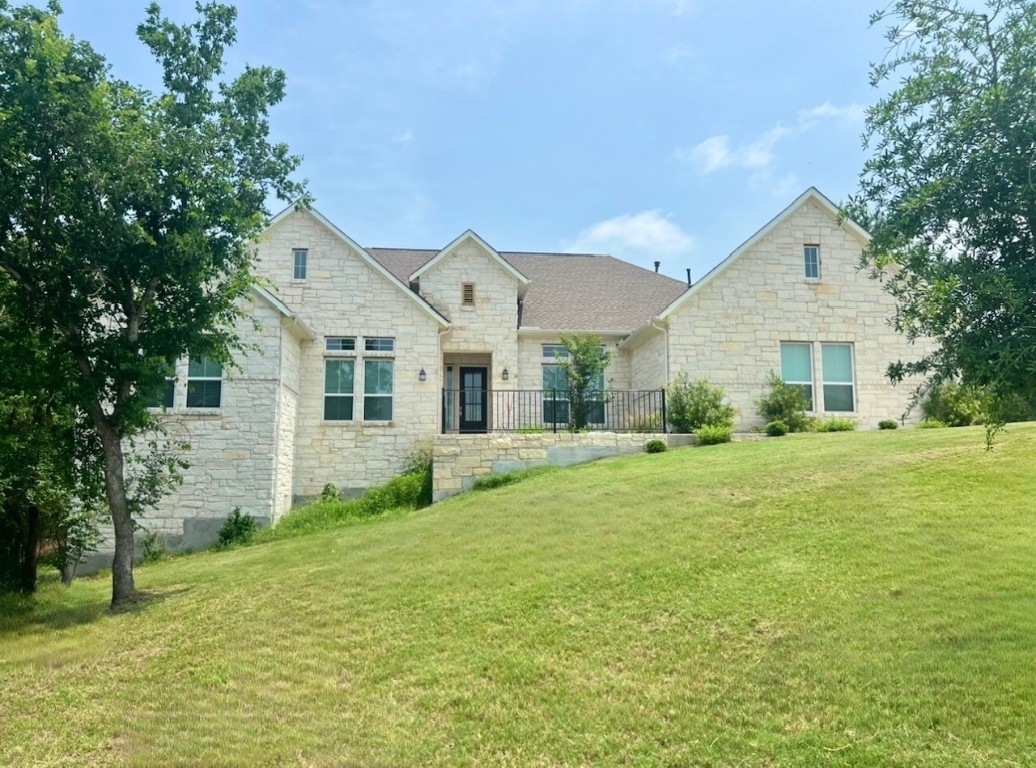 a front view of a house with a garden