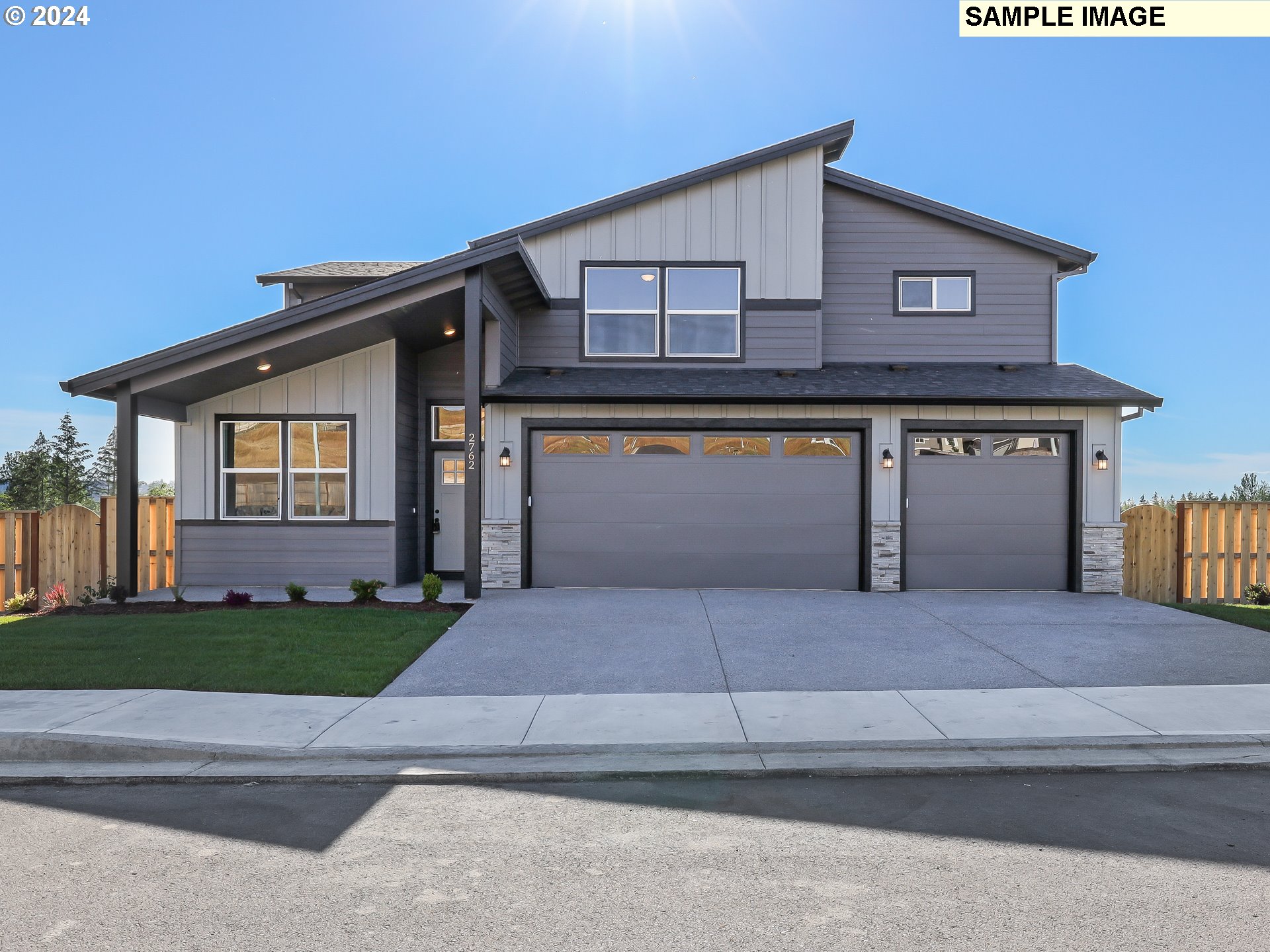 a front view of a house with a garden and garage