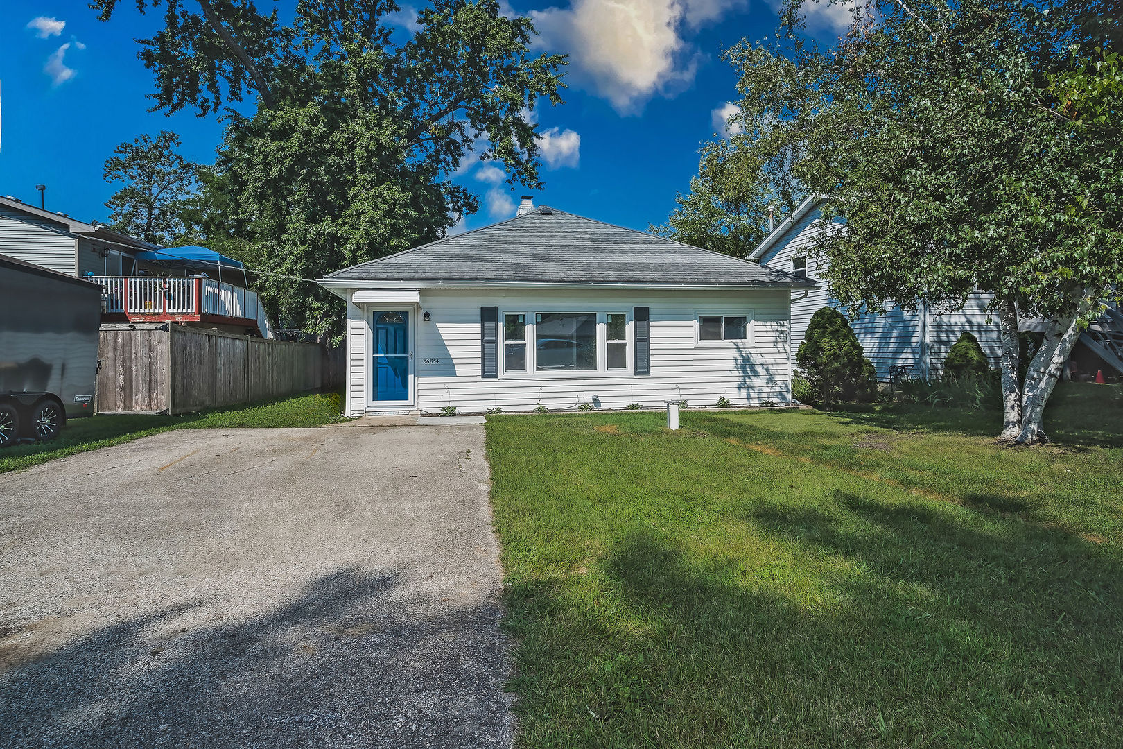 a front view of a house with a yard and porch