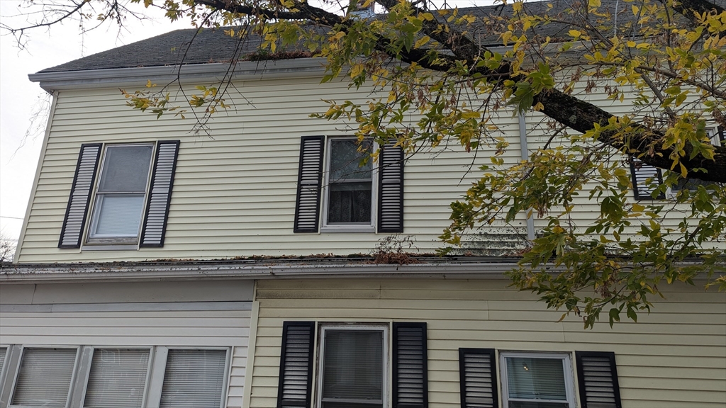 a view of a house with a window and brick wall