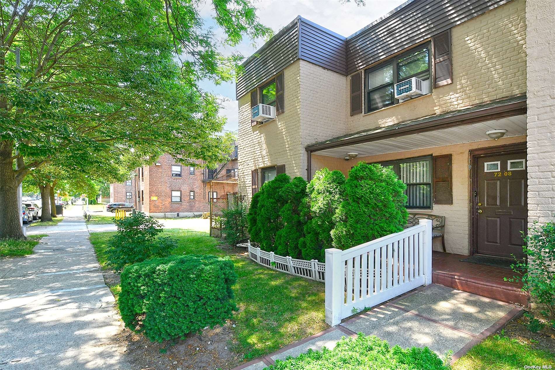 a view of a house with brick walls