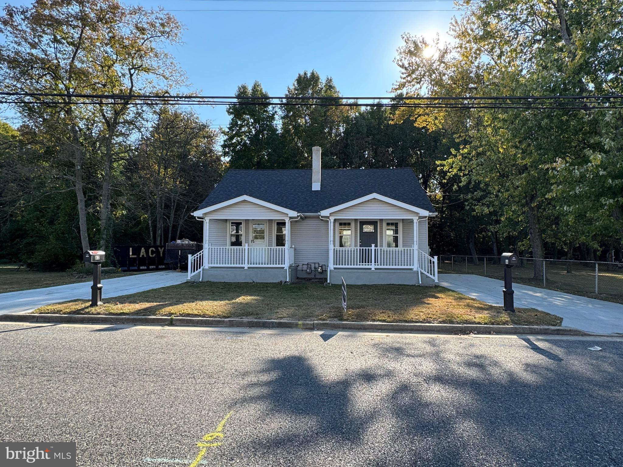 a view of house with garden and trees in the background