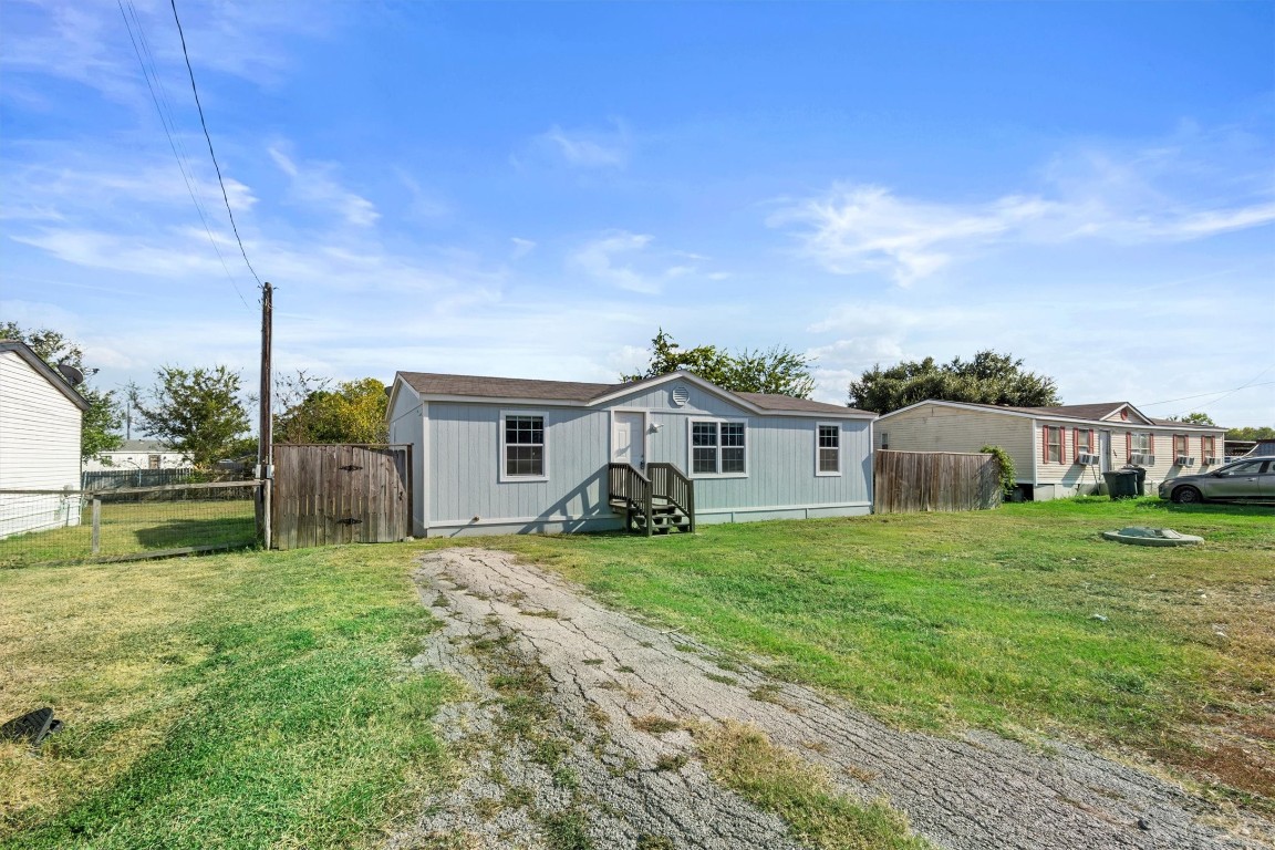 a view of a house with backyard and sitting area