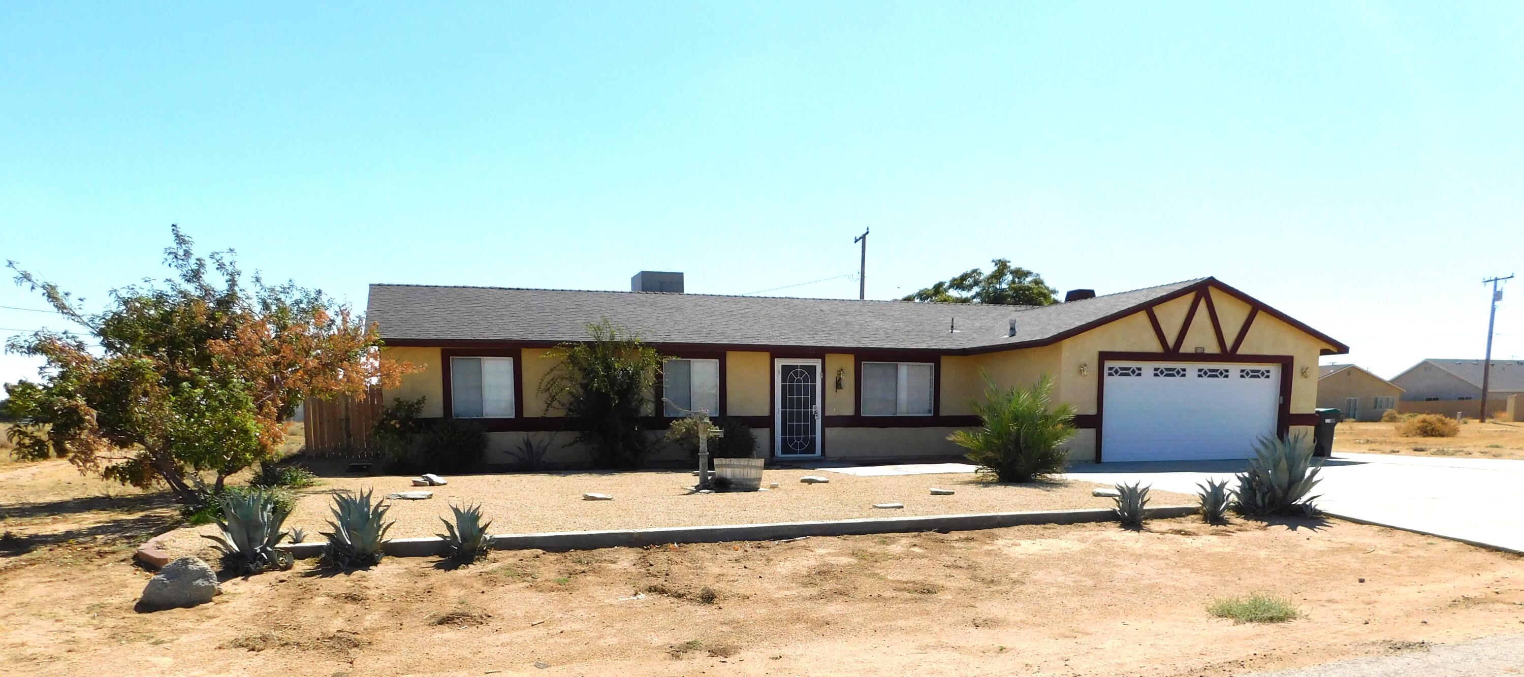 a view of a house with a yard and roof