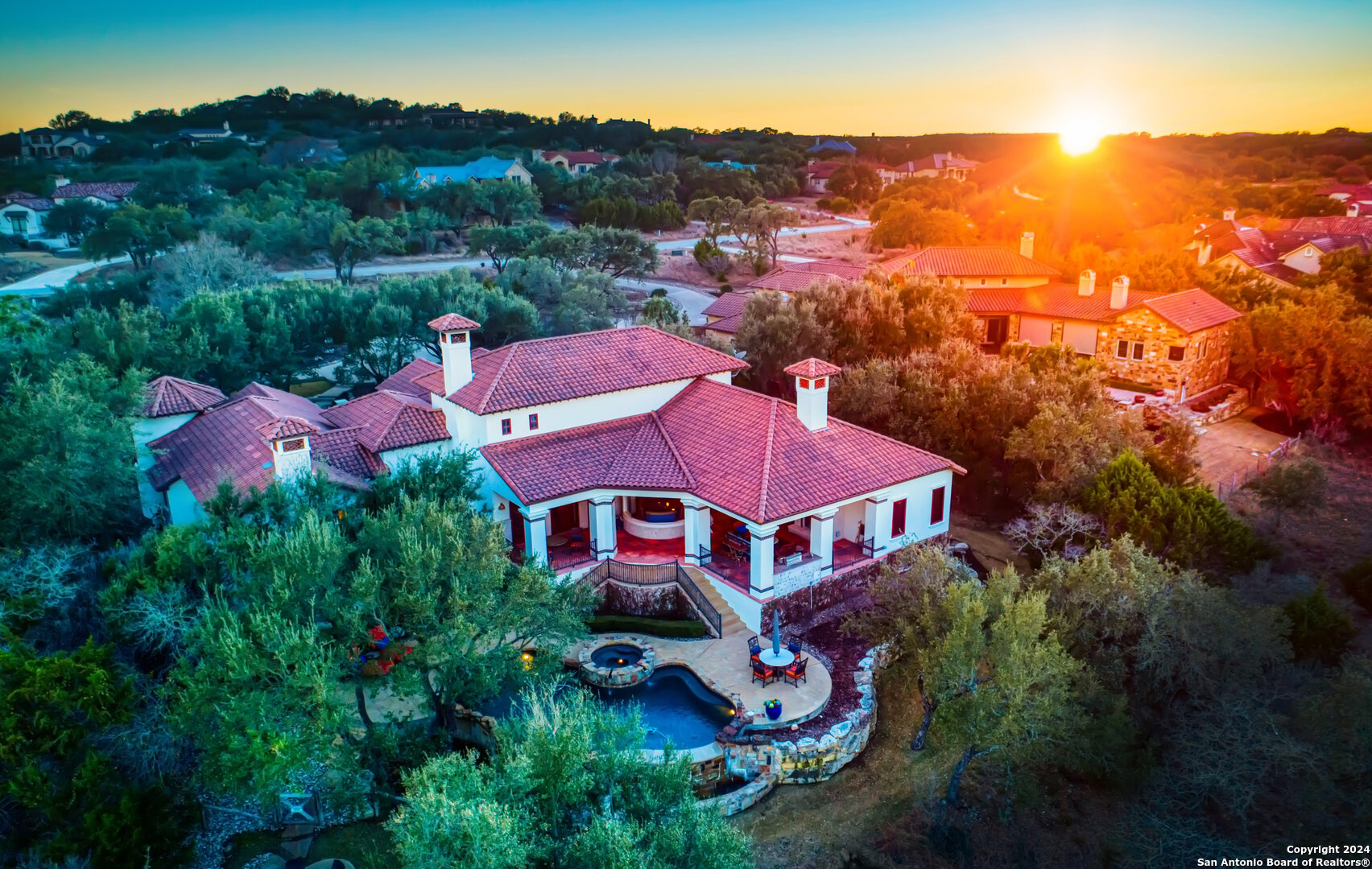 an aerial view of a house with a big yard