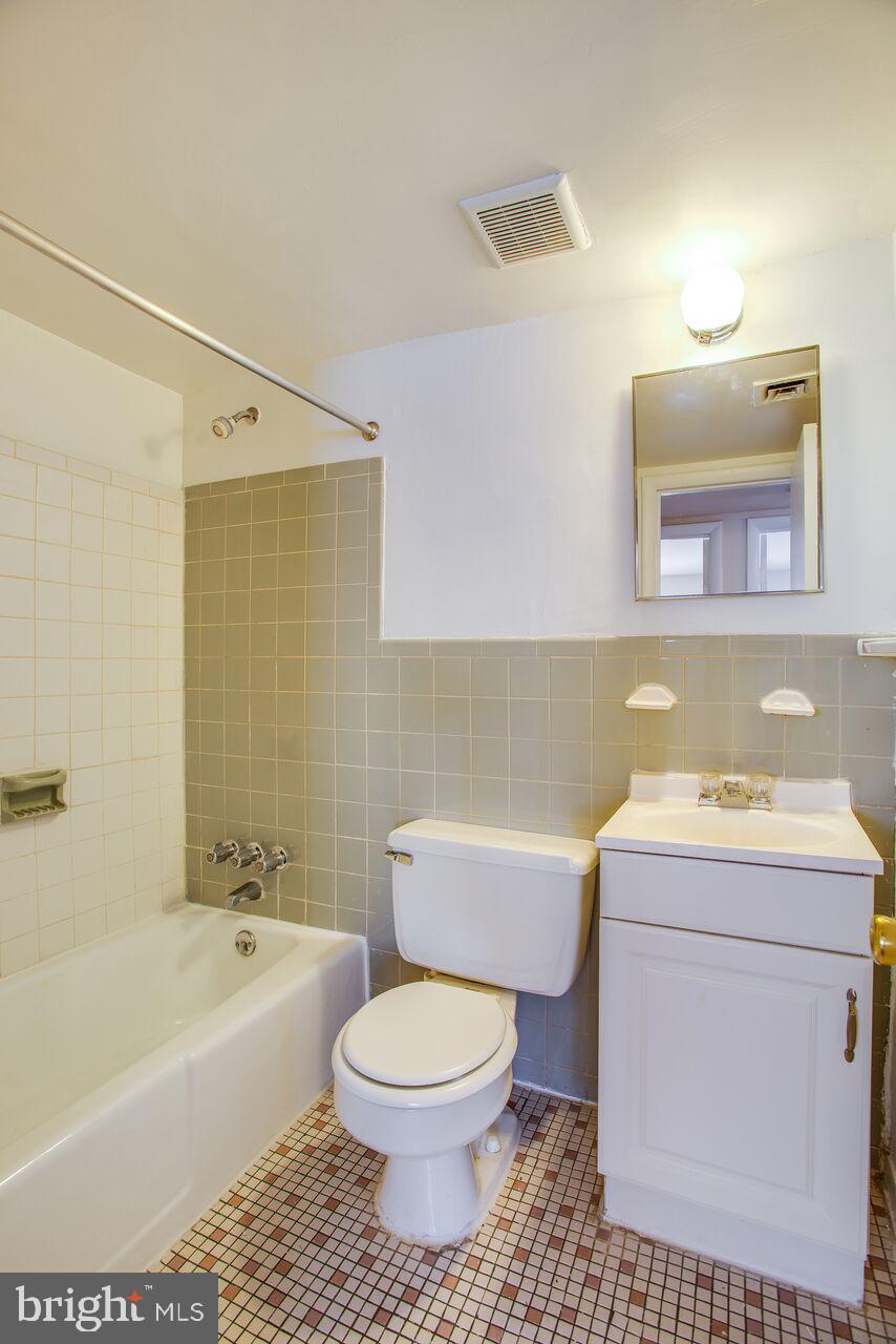 a bathroom with a toilet a sink and bathtub