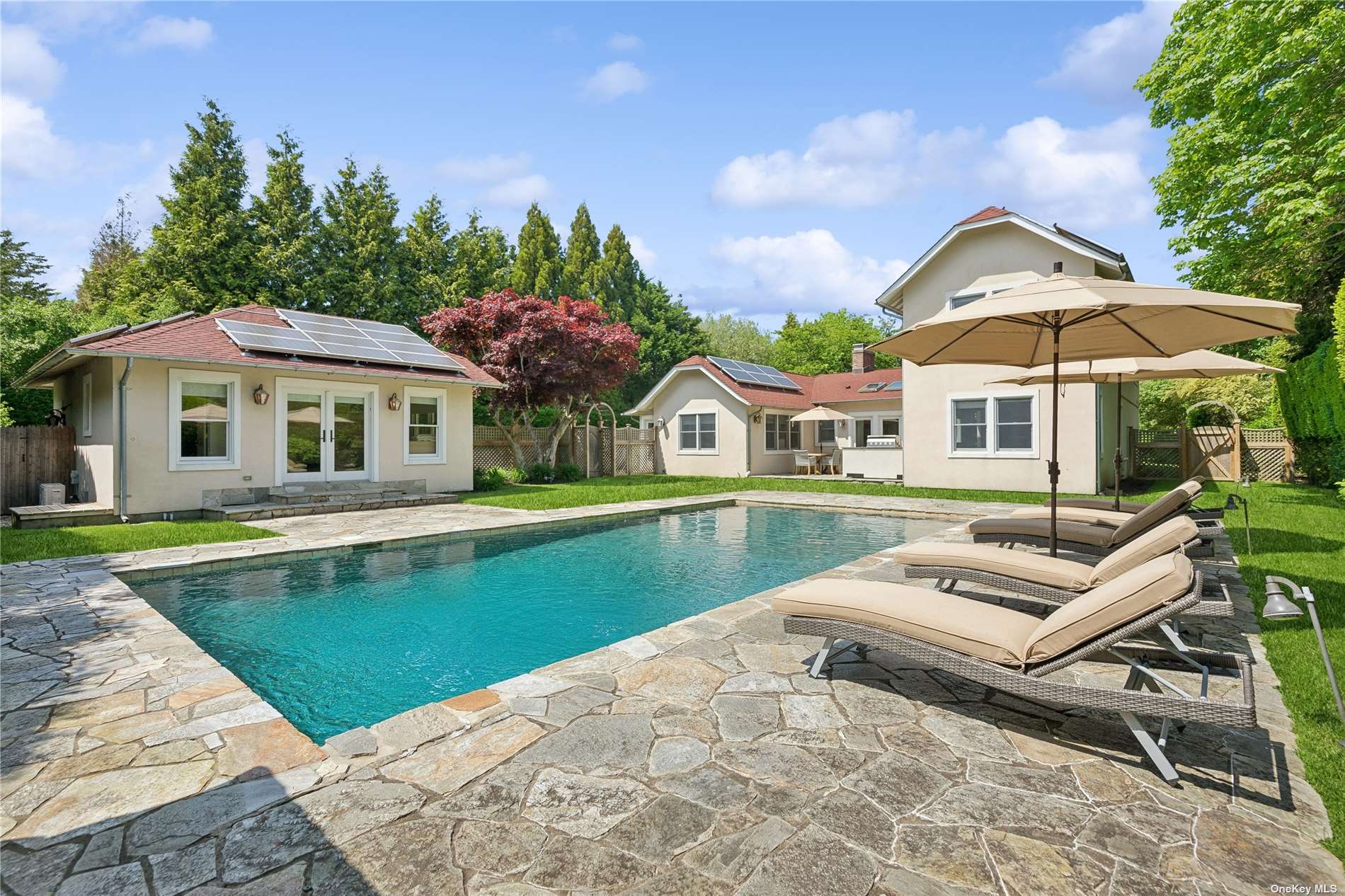 a view of house with swimming pool yard and outdoor seating