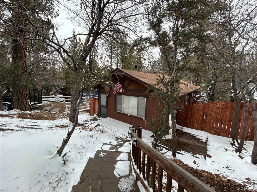 a view of a house with snow on the road