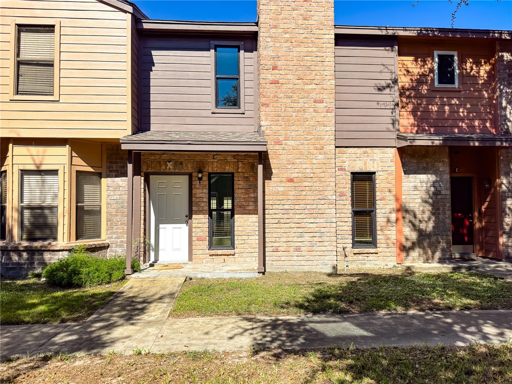 a view of a house with brick walls