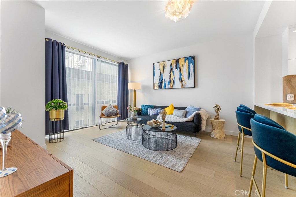 a living room with furniture a window and a flat screen tv