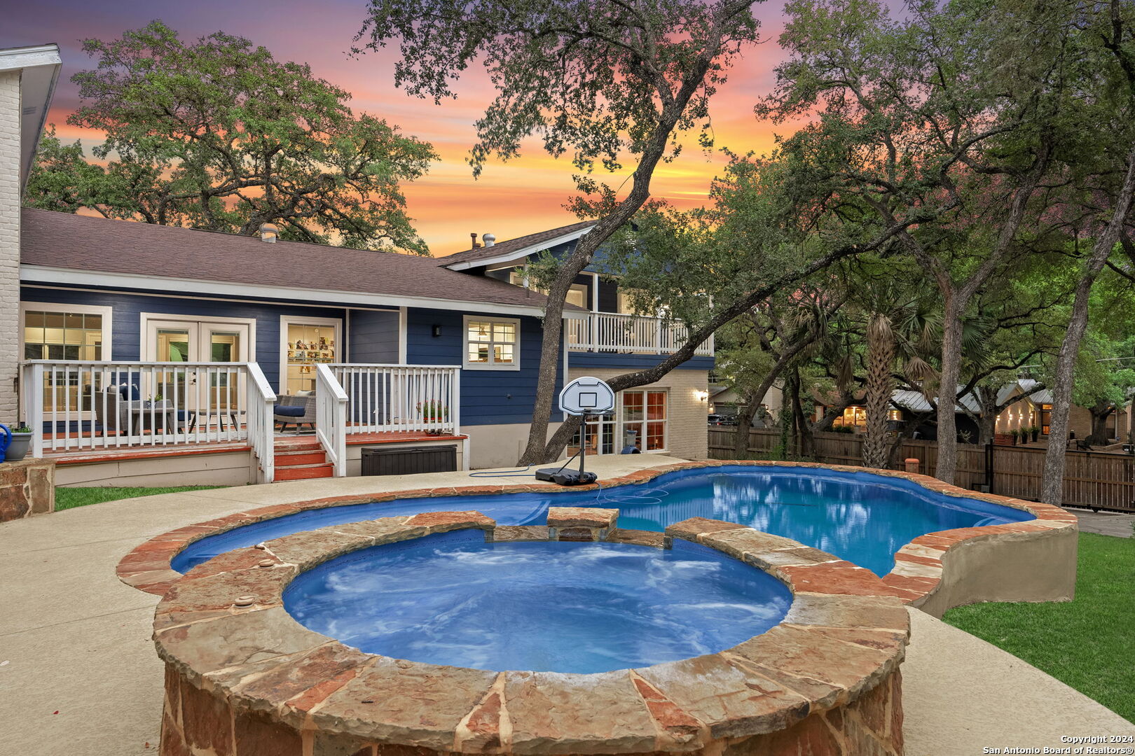 a view of a house with swimming pool and sitting area