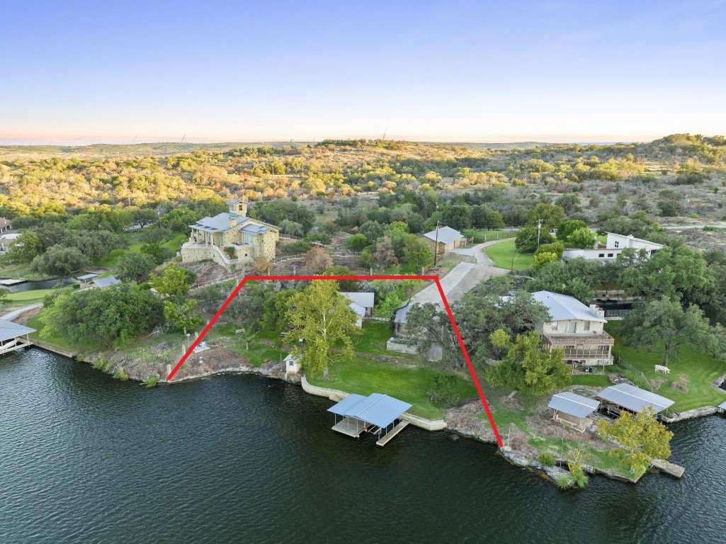 an aerial view of a houses with a lake